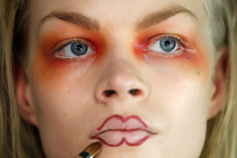 Image: A model is made up backstage for British designer Vivienne Westwood's Fall/Winter 2012-2013 women's ready-to-wear fashion show during Paris fashion week